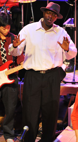 bayo singing with hands lifted